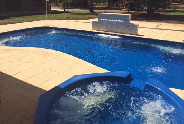 Pool with water feature and spa — Darwin Fibreglass Pools & Spas In Winnellie, NT