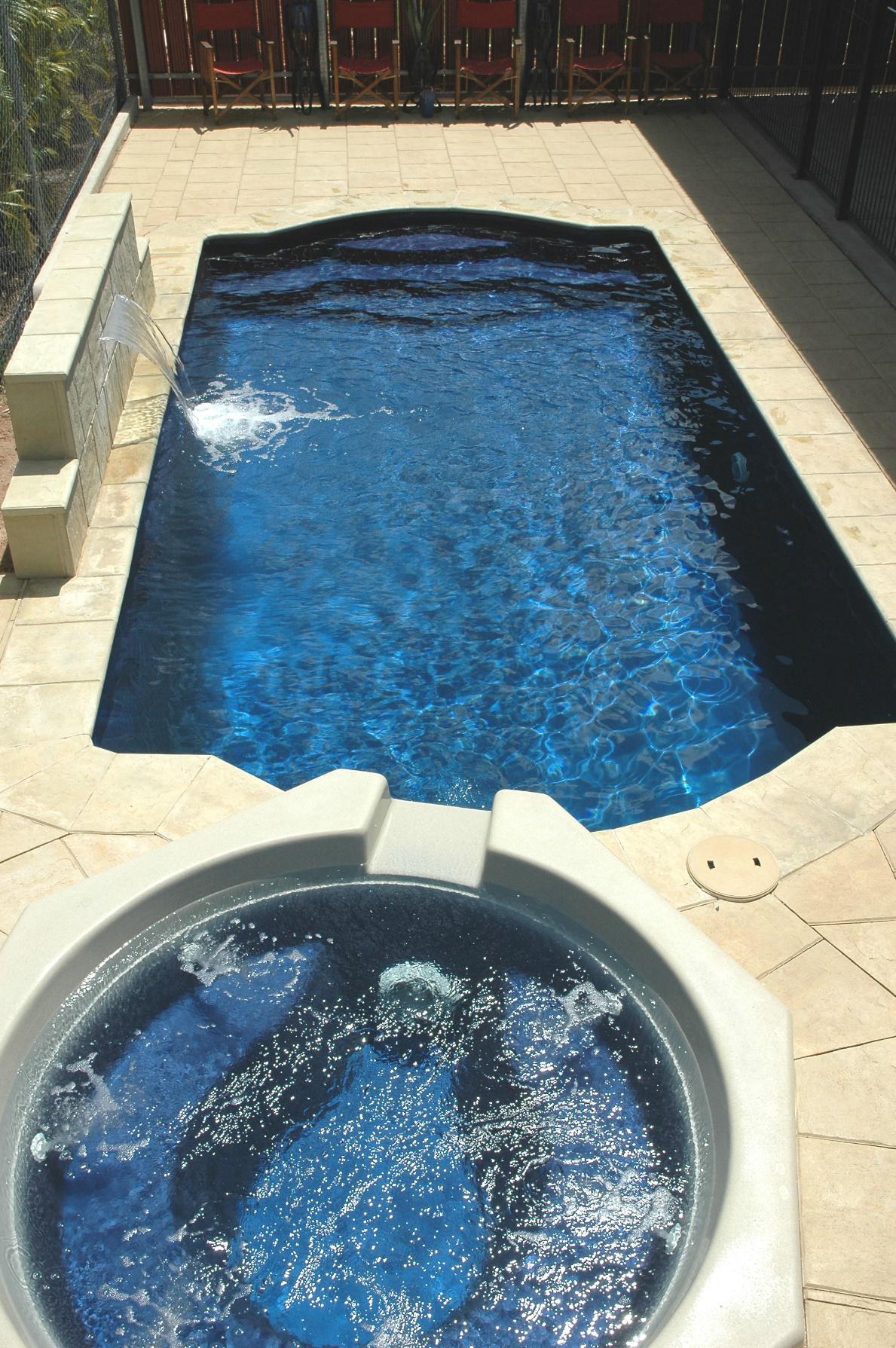 Pool with spa and cream stone tiles — Darwin Fibreglass Pools & Spas In Winnellie, NT
