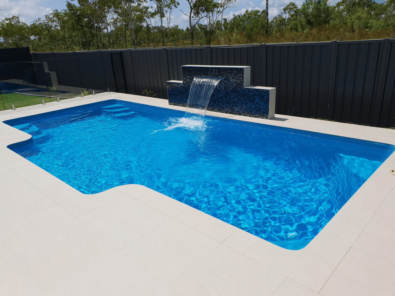 Pool with stone fountain — Darwin Fibreglass Pools & Spas In Winnellie, NT