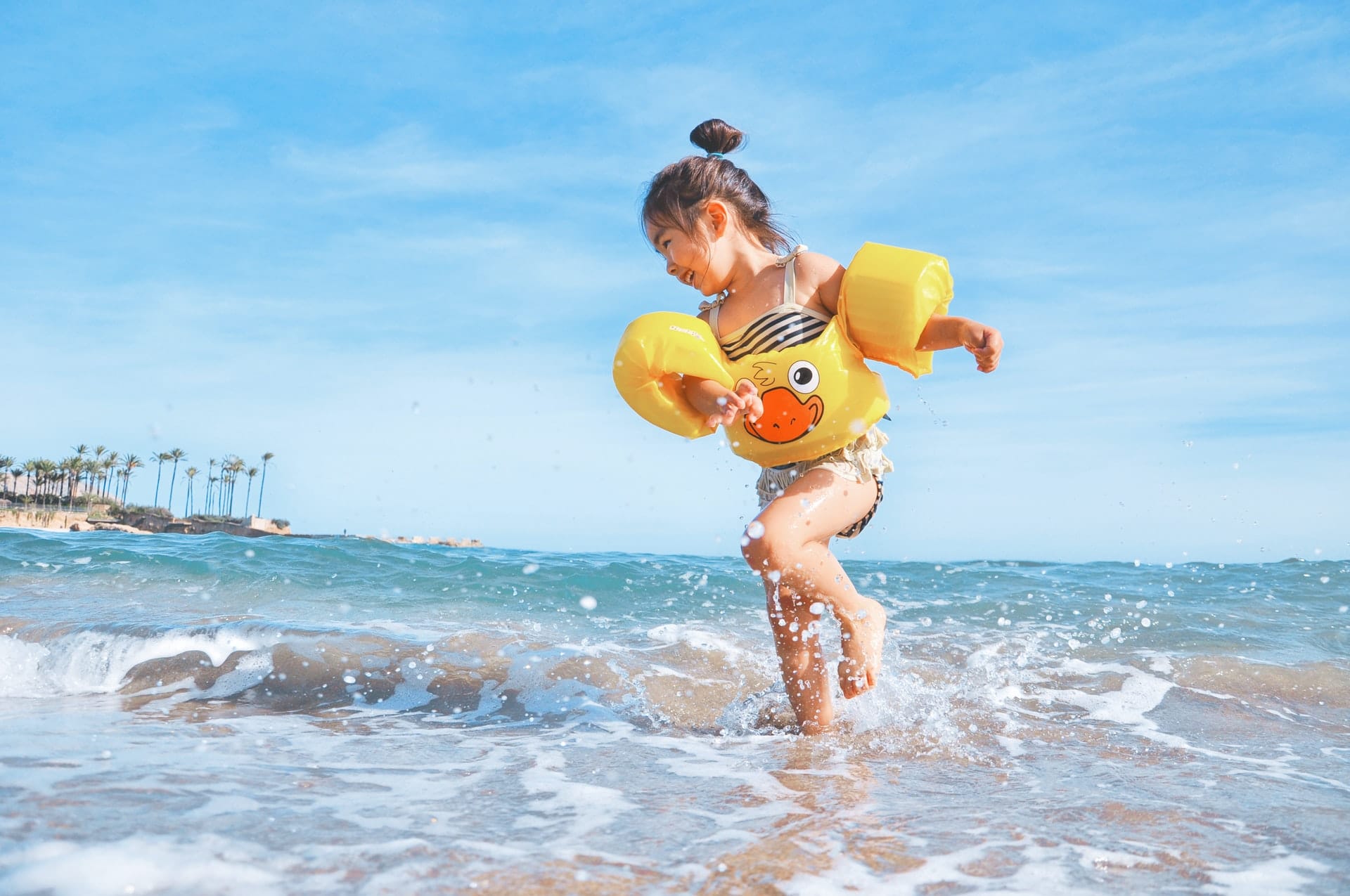 Little girl with floaties on the beach — Darwin Fibreglass Pools & Spas In Winnellie, NT