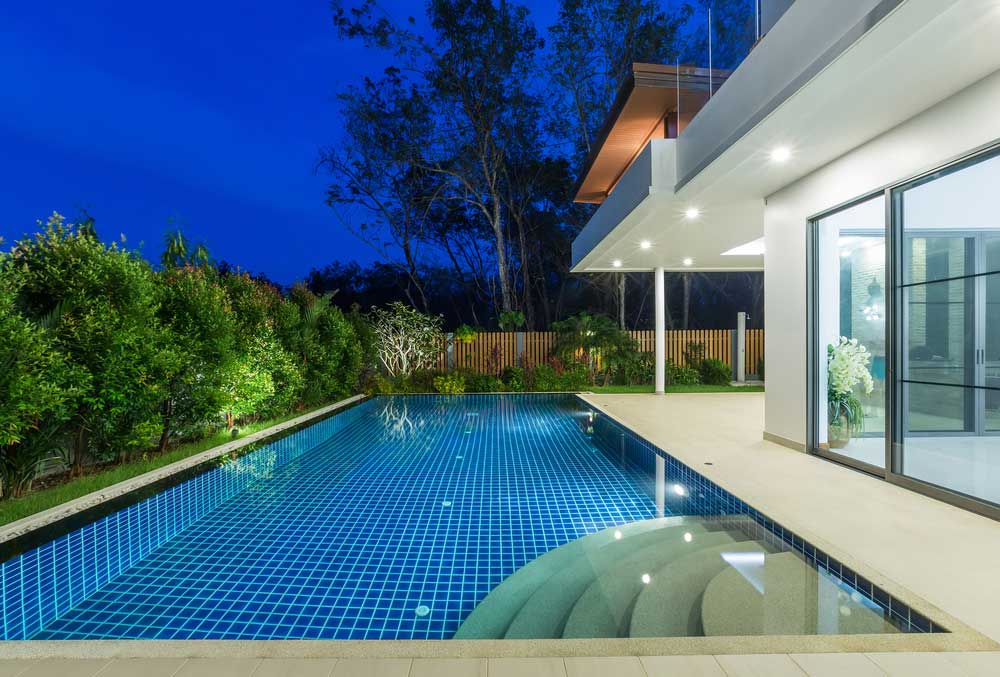 Luxury swimming pool with night lights — Darwin Fibreglass Pools & Spas In Winnellie, NT