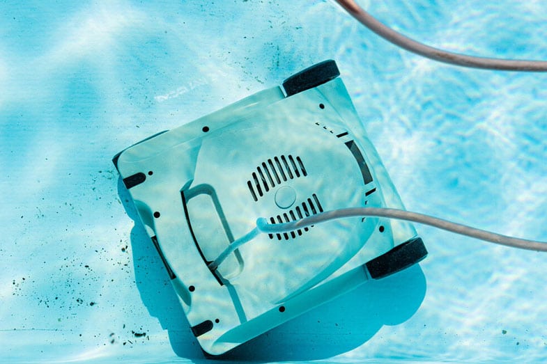 Top View Of An Underwater Automatic Robotic Pool Vacuum Cleaner Cleaning The Dirt On The Floor — Darwin Fibreglass Pools & Spas In Winnellie, NT